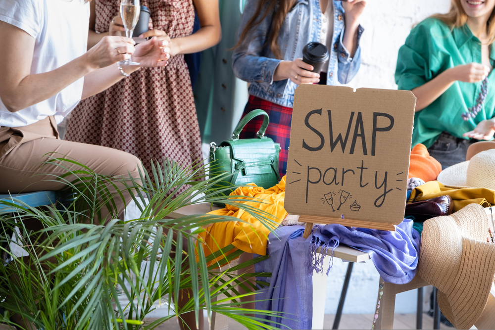 Young women at swap party. Casual clothes, shoes, hats, bags, jewellery
